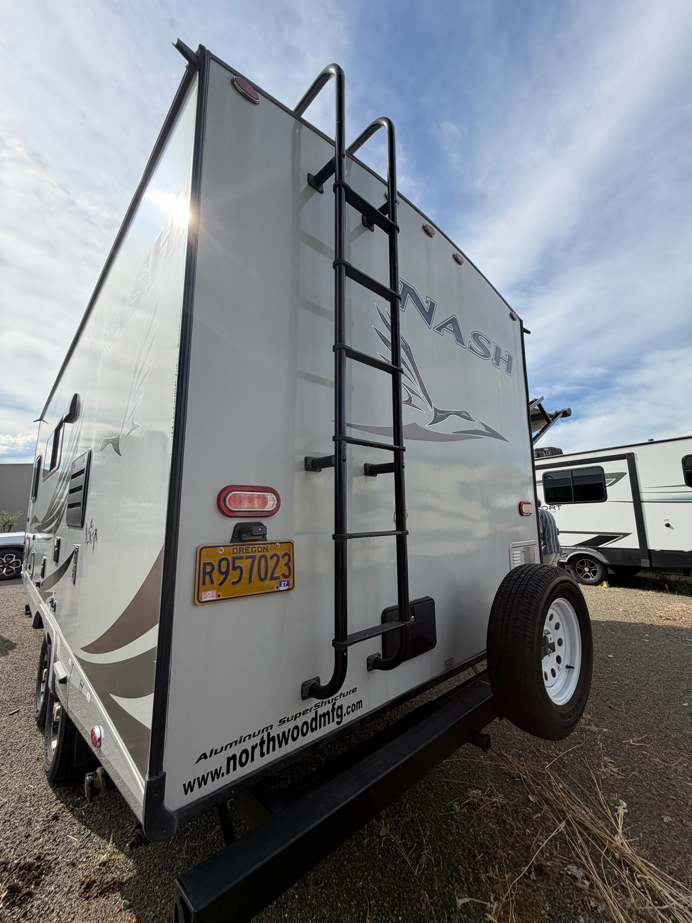 Rear exterior with license plate, spare tire, and roof rack
