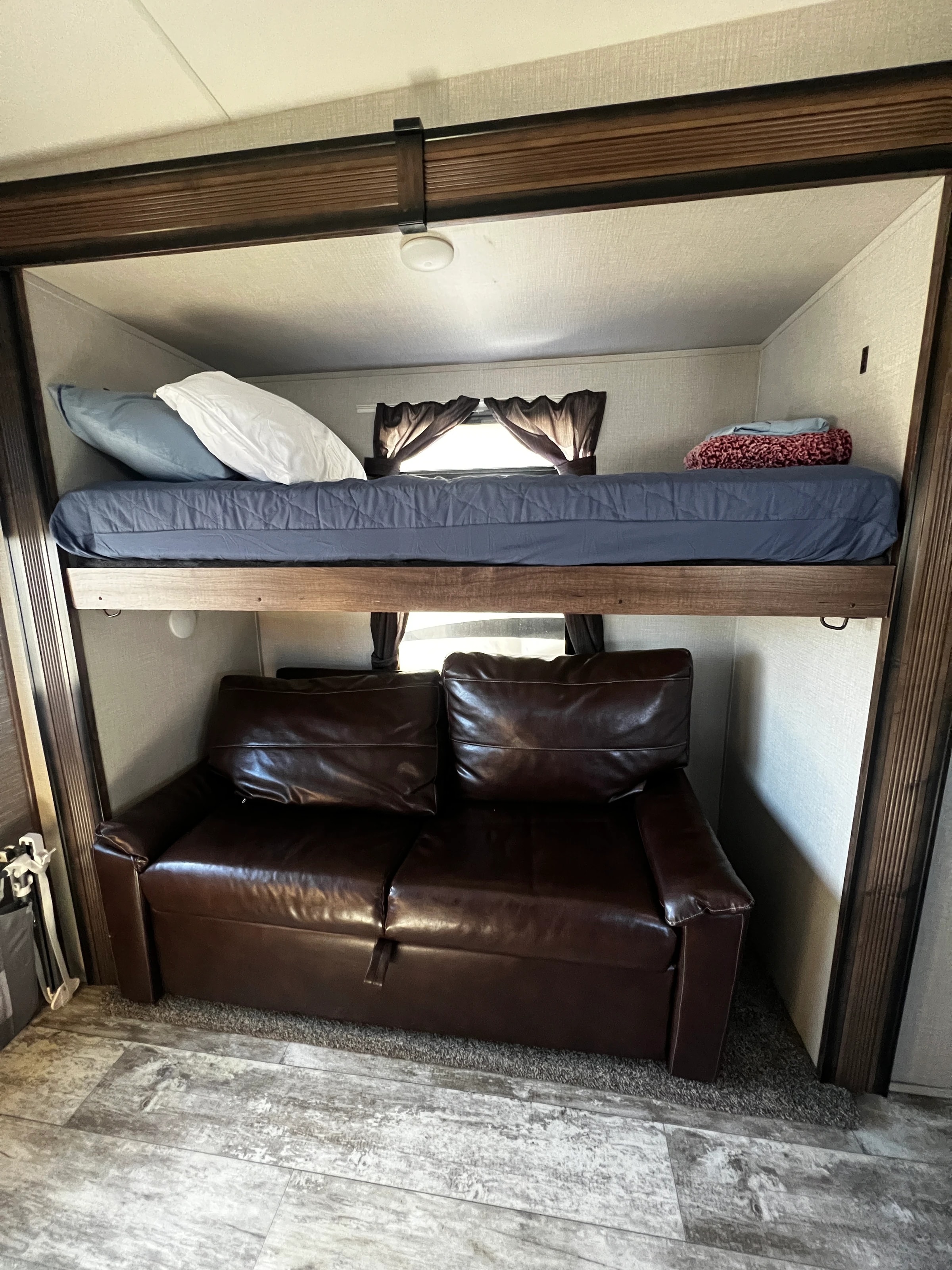 Bunk bed above a jackknife sofa in the bunk room
