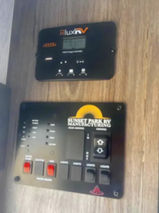 Close-up of the interior control panel with battery charge controller and light switches
