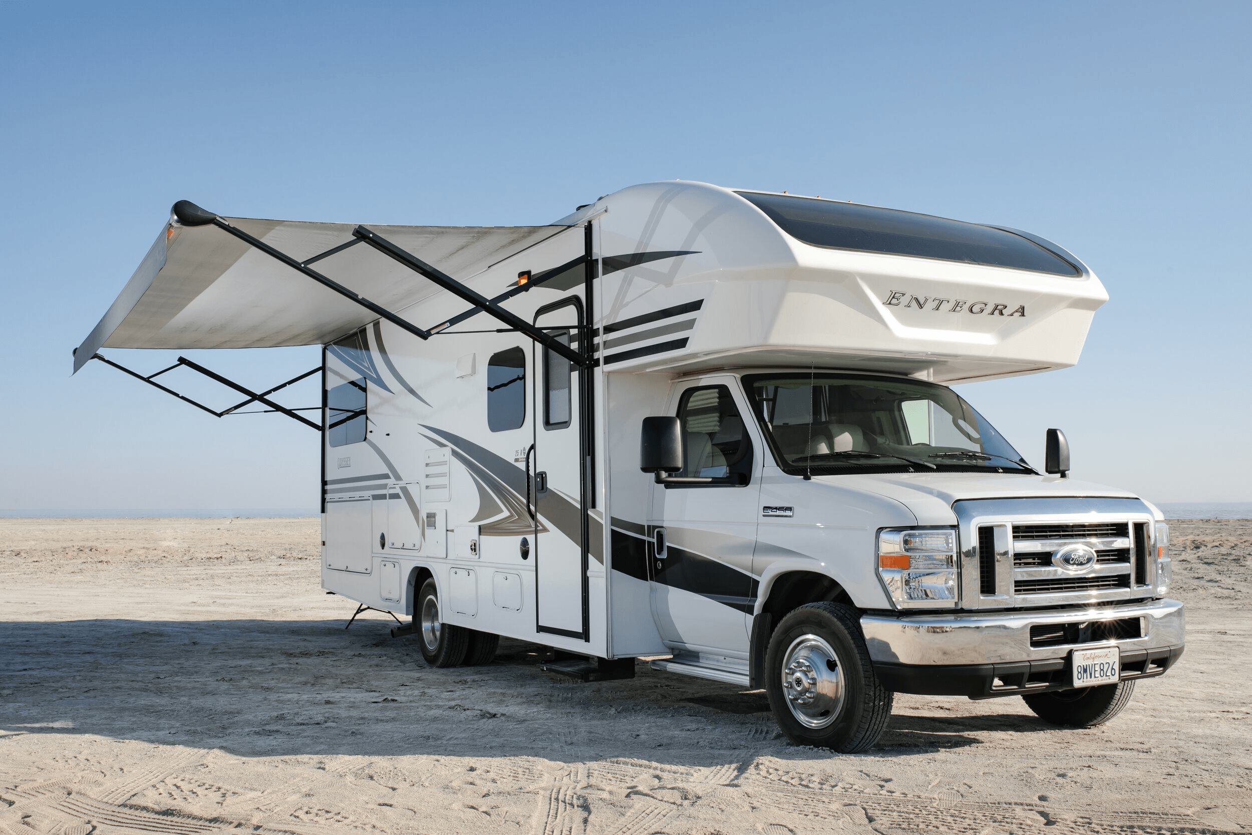 Class C motorhome parked with the awning extended