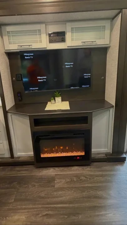 Entertainment center with wall-mounted TV and electric fireplace