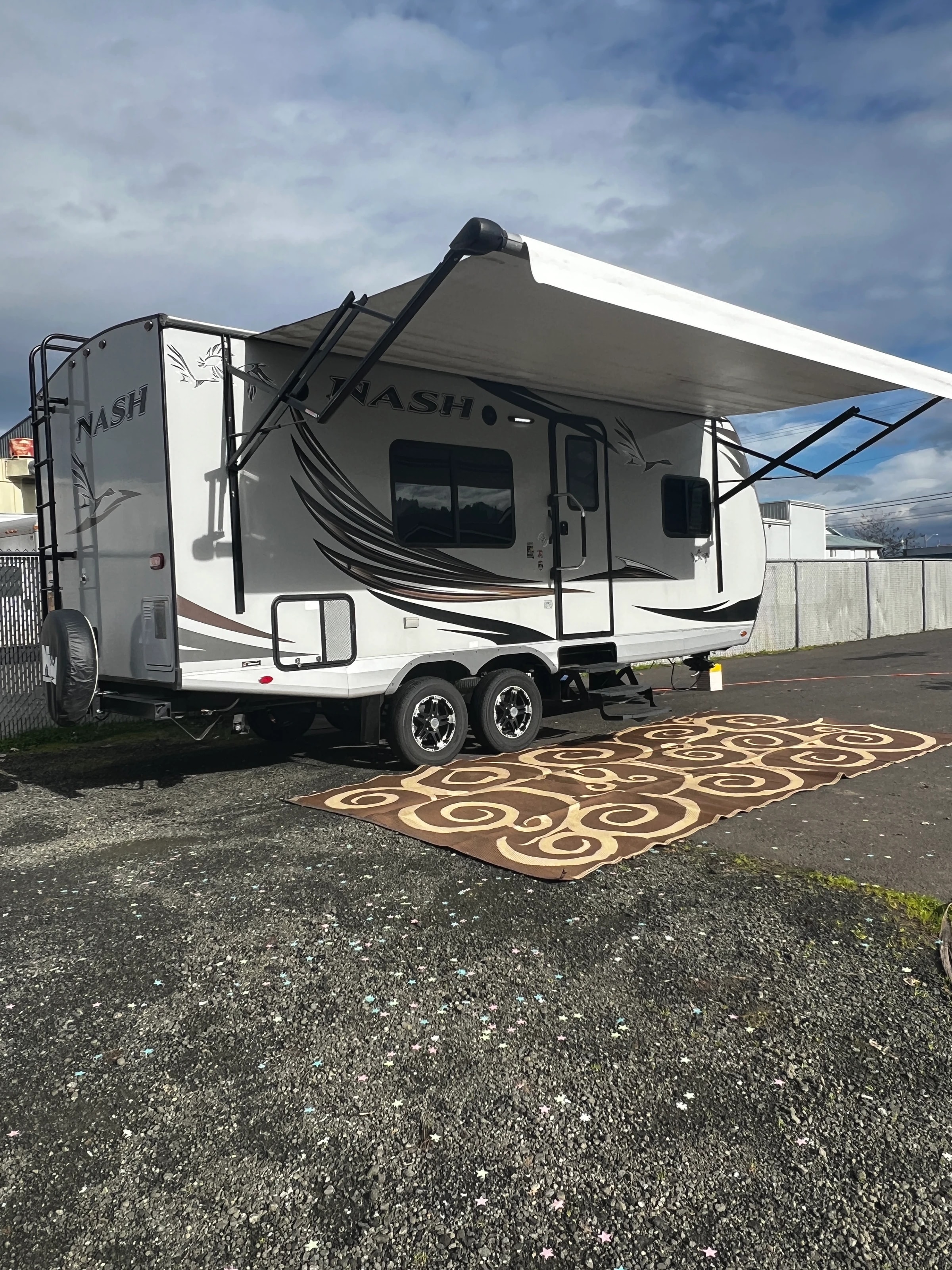 The Nash with its awning out over a patio mat