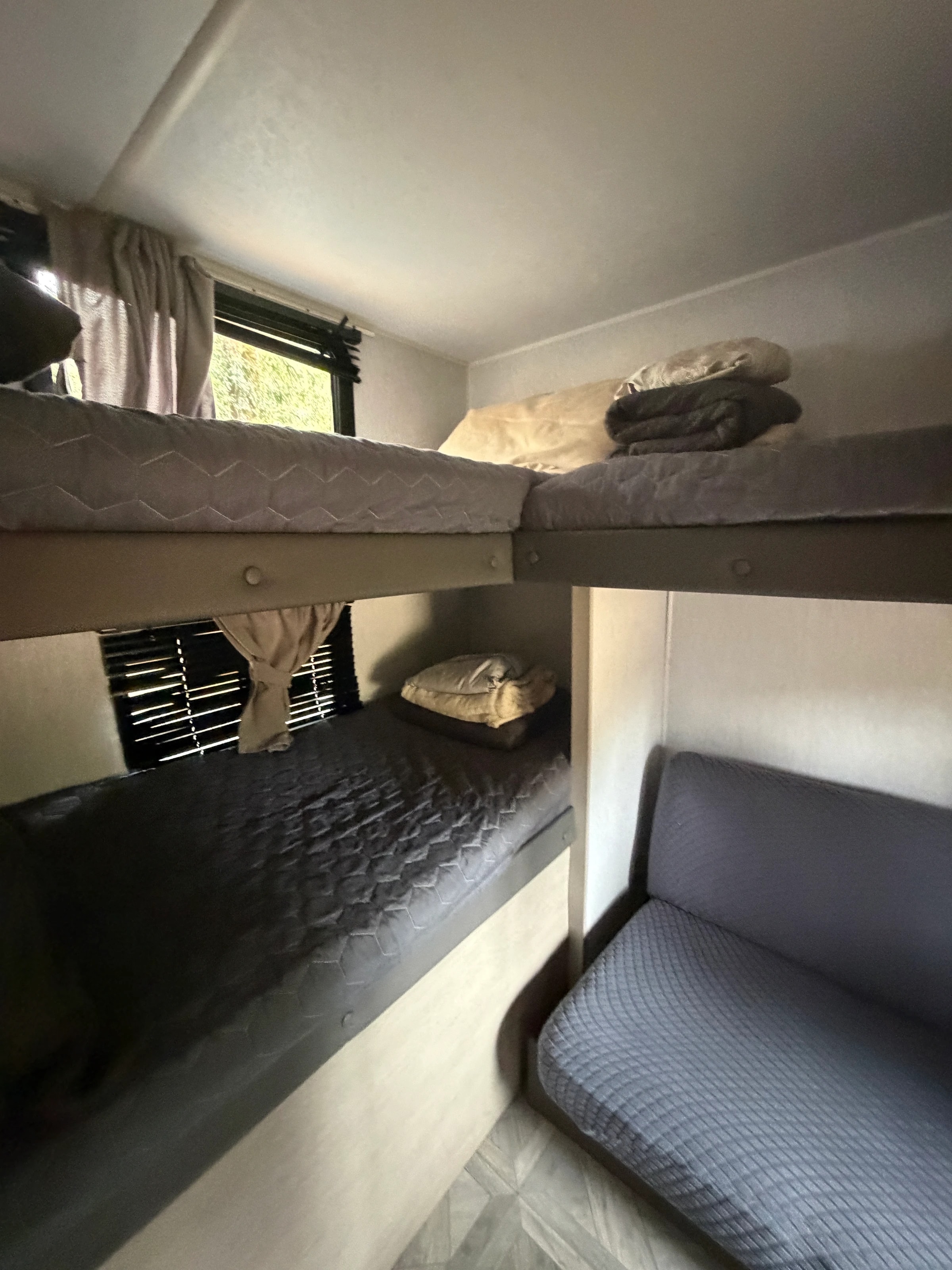 Close view of the bunk beds and surrounding cabinetry near the rear window