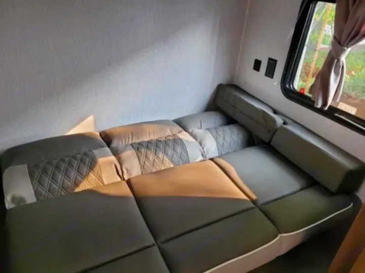 Sectional sofa cushions arranged flat to show its use as a sleeping surface