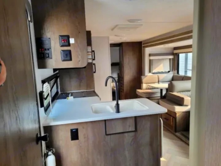 Kitchen island sink with view through to the dinette and lounge area