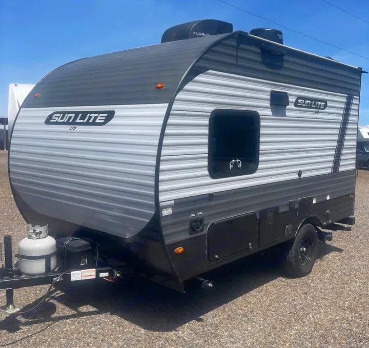 Front three-quarter view of the rounded front cap with propane tank and hitch