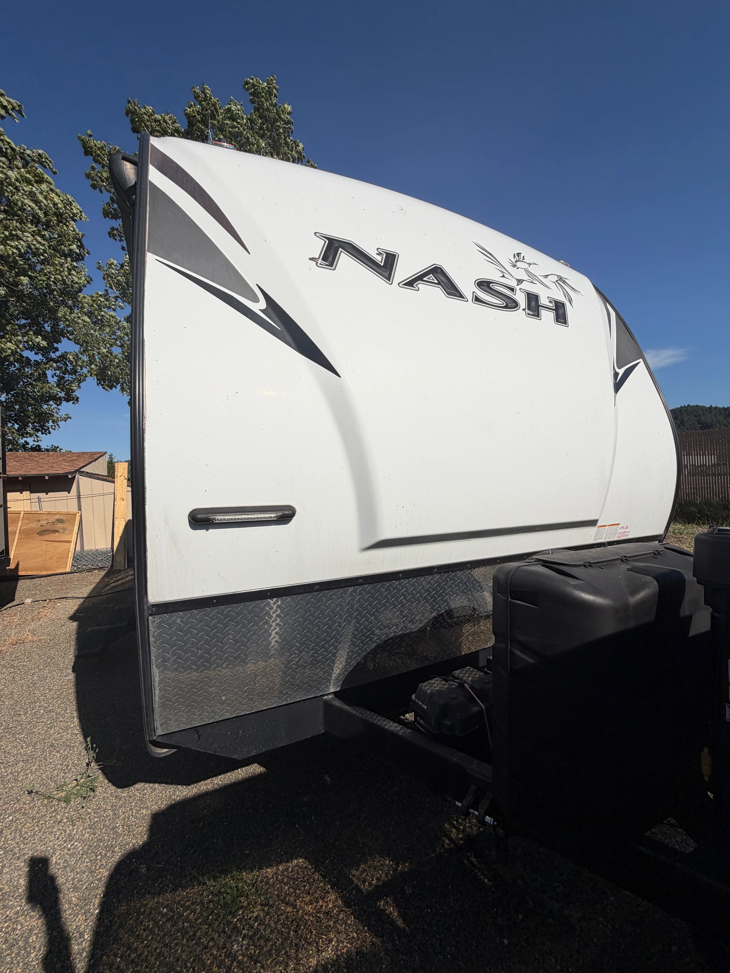 Rear corner exterior with NASH decal and roof ladder rack